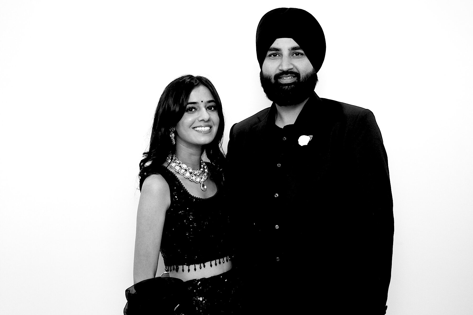 Smiling couple in evening wear photographed in black and white
